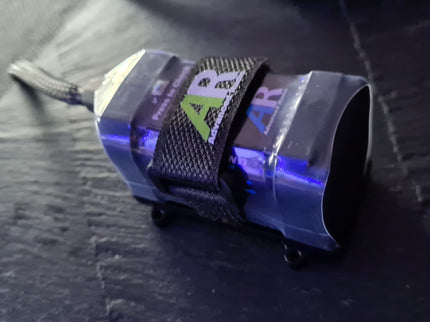 AR Li+ 6K Smart Battery with a strap on a dark surface