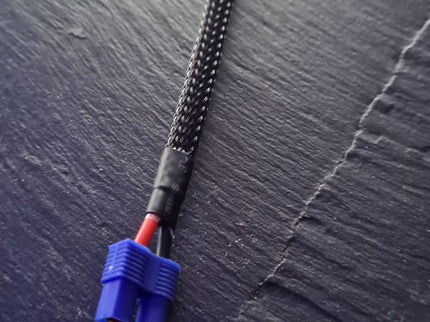 Cable with a blue connector on a textured gray surface