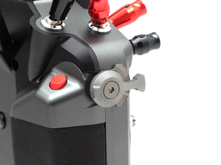 Close-up of a mechanical device with red and black components on a white background