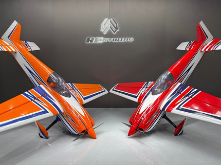 Two model airplanes, one orange and white, the other red and white, on a gray surface with a brand logo in the background.