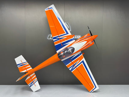 Orange and white model airplane on a gray background