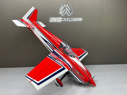 Red and white model airplane on a gray surface with a brand logo in the background.