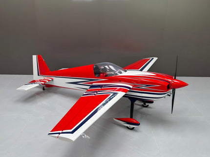 Red and white model airplane on a gray surface with a neutral background