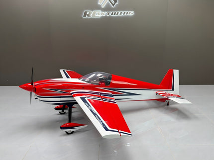 Red and white model airplane on a gray surface with a blurred background