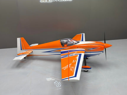 Orange and white model airplane on a gray surface with a neutral background