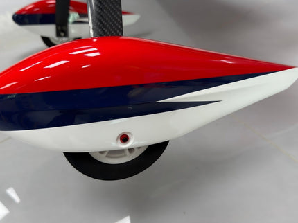Red, white, and blue wheel pants on a white floor