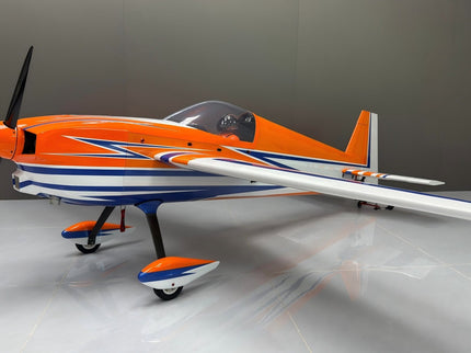 Orange and blue model airplane on a gray background