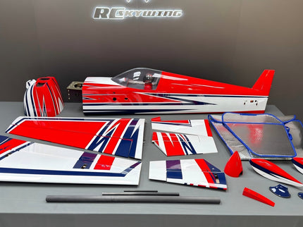Model airplane parts with red, white, and blue design on a gray surface.