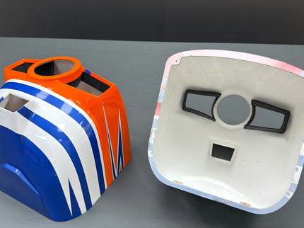 Two colorful cowls on a gray surface
