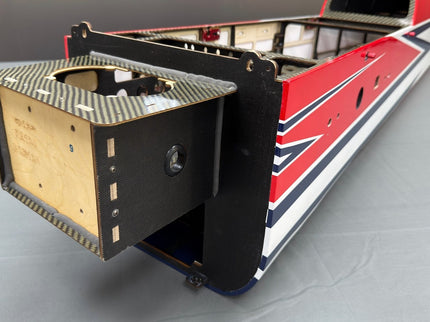 Model of aeroplane with a red/blue design on a gray surface