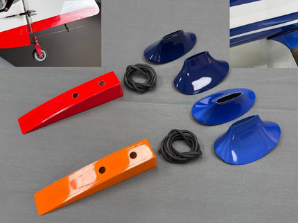 Colorful boat parts including red, blue, and orange covers on a gray surface.