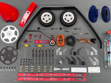 Collection of model plane parts and tools on a gray background