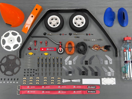 Collection of model building parts and tools on a gray surface