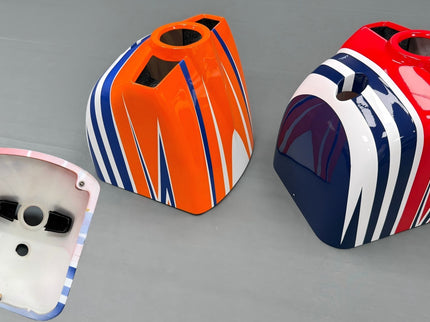 Three colorful airplane cowls on a gray background