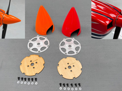 Model airplane parts including wings, tail fins, and propeller on a gray surface.