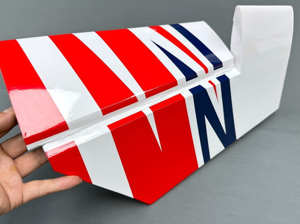 Model airplane stab and elevator in red design held by a hand on a gray background