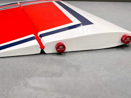 Red, white, and blue pool table with red pool cues on a gray surface