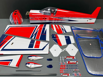 Model airplane parts with red, white, and blue design on a gray surface