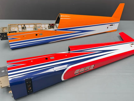Two model airplane wings with colorful stripes on a gray surface