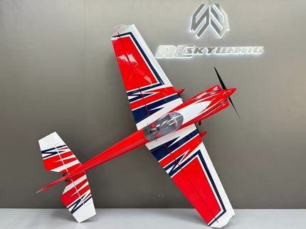 Red, white, and blue model airplane on a gray surface with a branded background