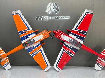 Two model airplanes, one orange and white, the other red and white, on a gray surface with a branded background.