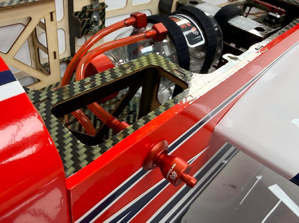 Close-up of a red and white model car with visible engine components.