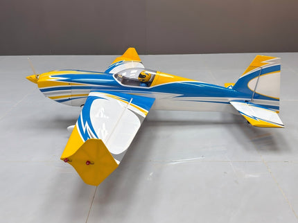 Model airplane with blue and yellow design on a gray surface