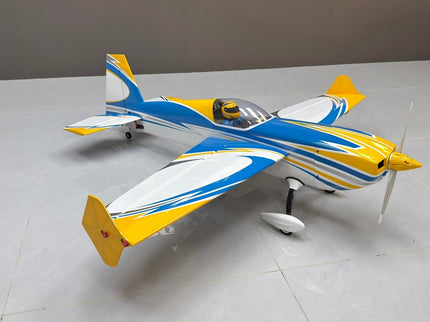 Model airplane with blue and yellow design on a light gray surface