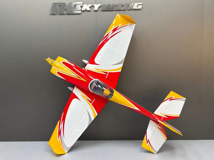 Model airplane with red and yellow design on a gray background, featuring the 'R/C Skywing' brand.