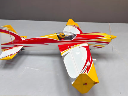 Model airplane with red, white, and yellow colors on a gray background