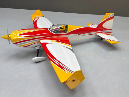 Model airplane with red, yellow, and white colors on a gray surface