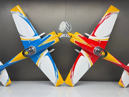 Two model airplanes, one blue and yellow, the other red and yellow, on a reflective surface with a dark background.