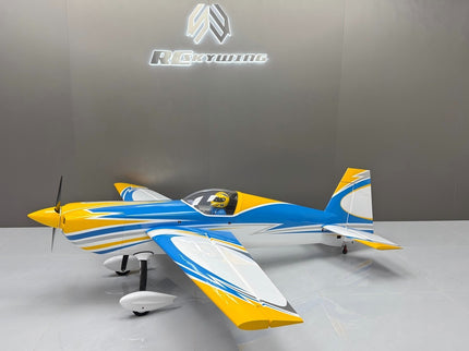 Model airplane on a gray surface with a branded wall in the background
