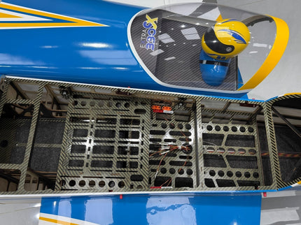 Close-up of a blue and yellow airplane with open canopy showing internal structure.