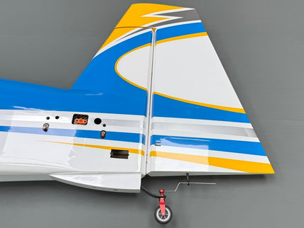 Model airplane tail section with blue, white, and orange design on a gray background