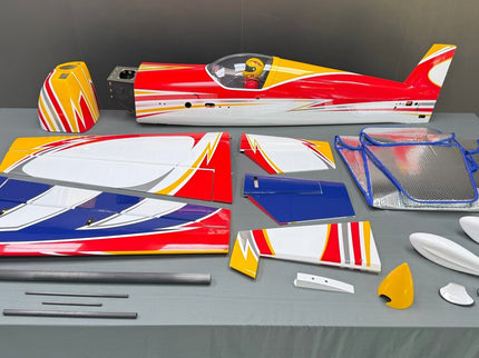 Model airplane parts on a gray surface with a dark background