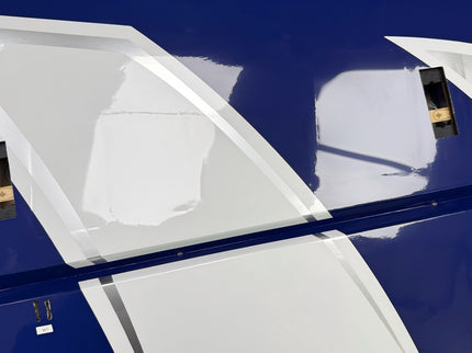 Close-up of a blue airplane with white winglets on a clear background