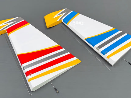 Two colorful model airplane wings on a gray background