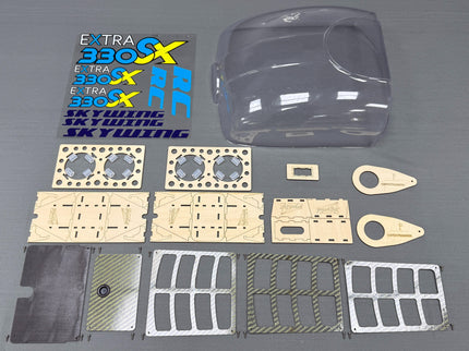 Model kit parts including a clear car body shell and various small components on a gray background.