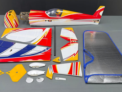 Model airplane parts on a gray surface with a dark background