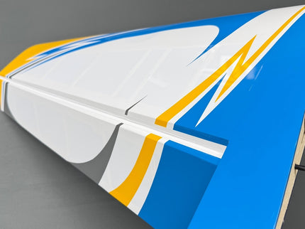 Model airplane wing with blue, white, and yellow design on a gray background