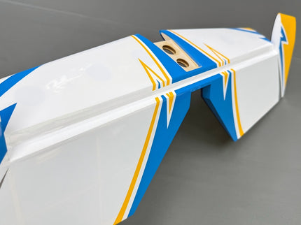 Close-up of a white, blue, and orange model airplane body on a gray background