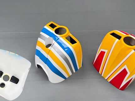 Three colorful rc skywing cowls on a gray background