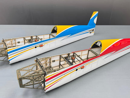 Two model airplane bodies with colorful stripes on a gray background