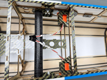 3D printer in operation with a partially printed object on a bed.