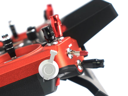 Close-up of a red and black mechanical device with various components on a white background