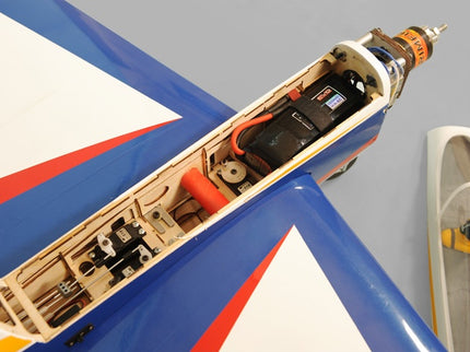 Phoenix Model TYPHOON 59" Size ARF Close-up of a model airplane's interior with visible wiring and components on a gray background.
