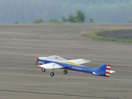 Phoenix Model TYPHOON 59" Size ARF Model airplane on a grassy field with trees in the background