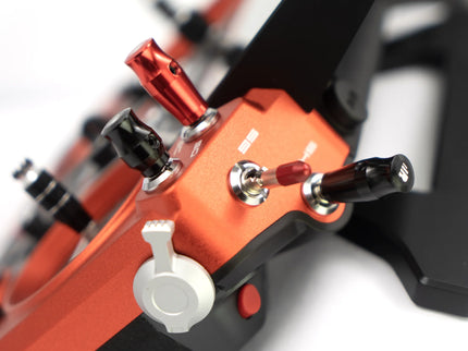 Close-up of a red and black mechanical component with visible branding on a white background