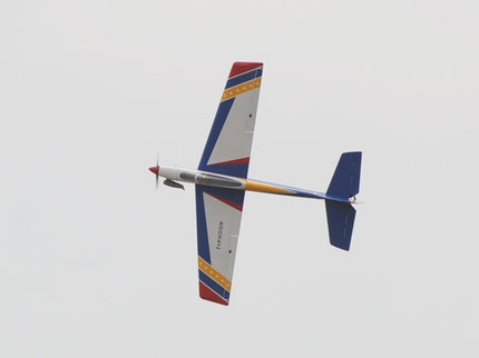 Colorful Phoenix Model TYPHOON 59" Size ARF model airplane flying against a clear sky